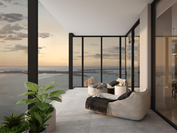 Modern balcony living area with glass walls, overlooking a sunset coastal city.